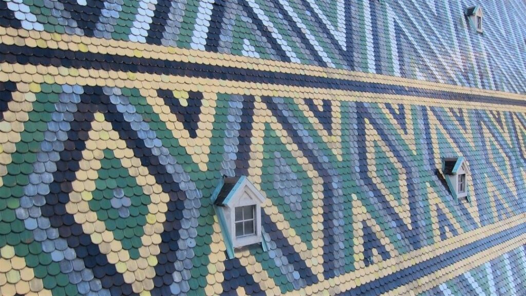 Colorful patterned tile roof with three dormer windows