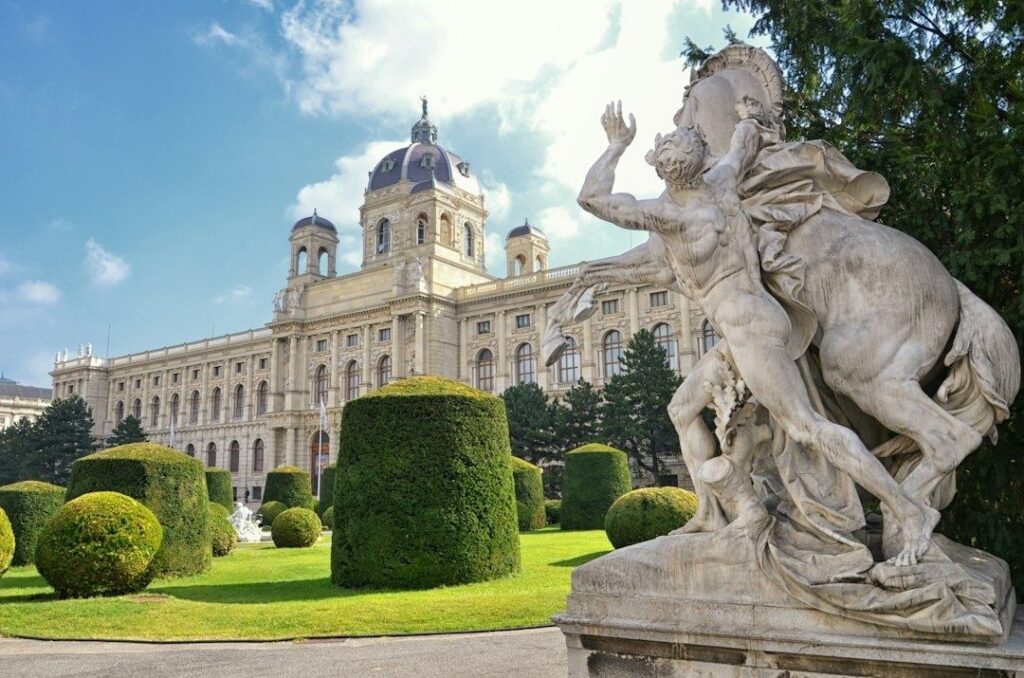 Historic Vienna museum and monumental sculpture in a formal garden